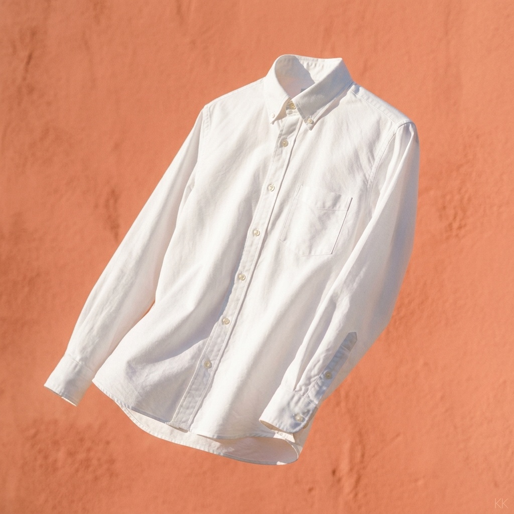 A single crisp cotton button-down shirt on an invisible mannequin form, caught mid-motion against a bright sunlit coral backdrop — luminous daylight, clean whites, airy 2026 lookbook energy. No logos, no faces, no readable text.