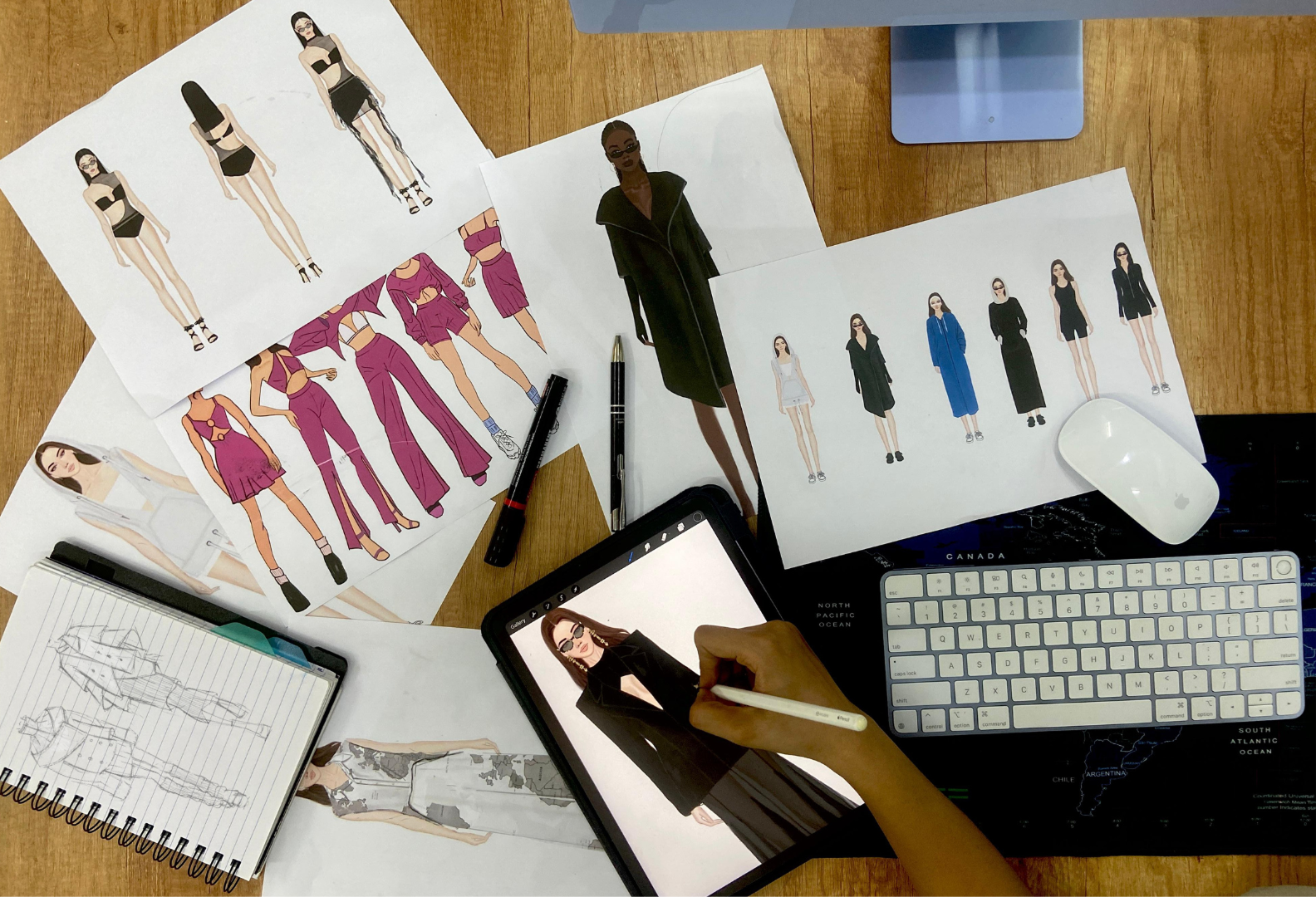 Fashion design concept and illustration process - designer's workspace with sketches and digital tools